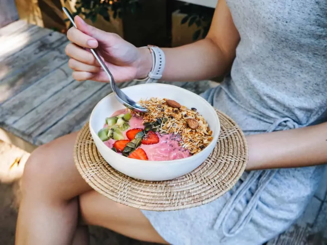 mujer disfrutando de granola en un cuenco