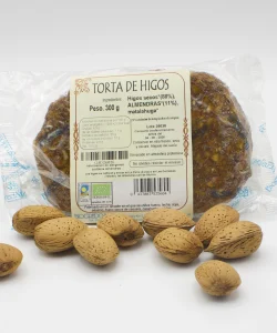 torta de higos con almendras ecológica envasada y varias almendras a su alrededor